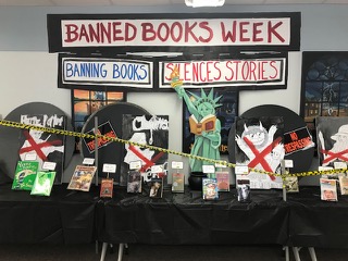 Interactive book exhibit with character cut-outs and displayed books
