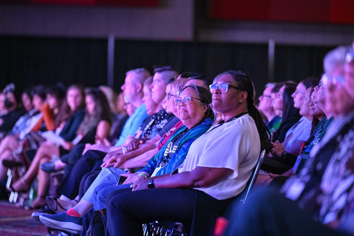 A group of people seated at a conference enjoying the panel