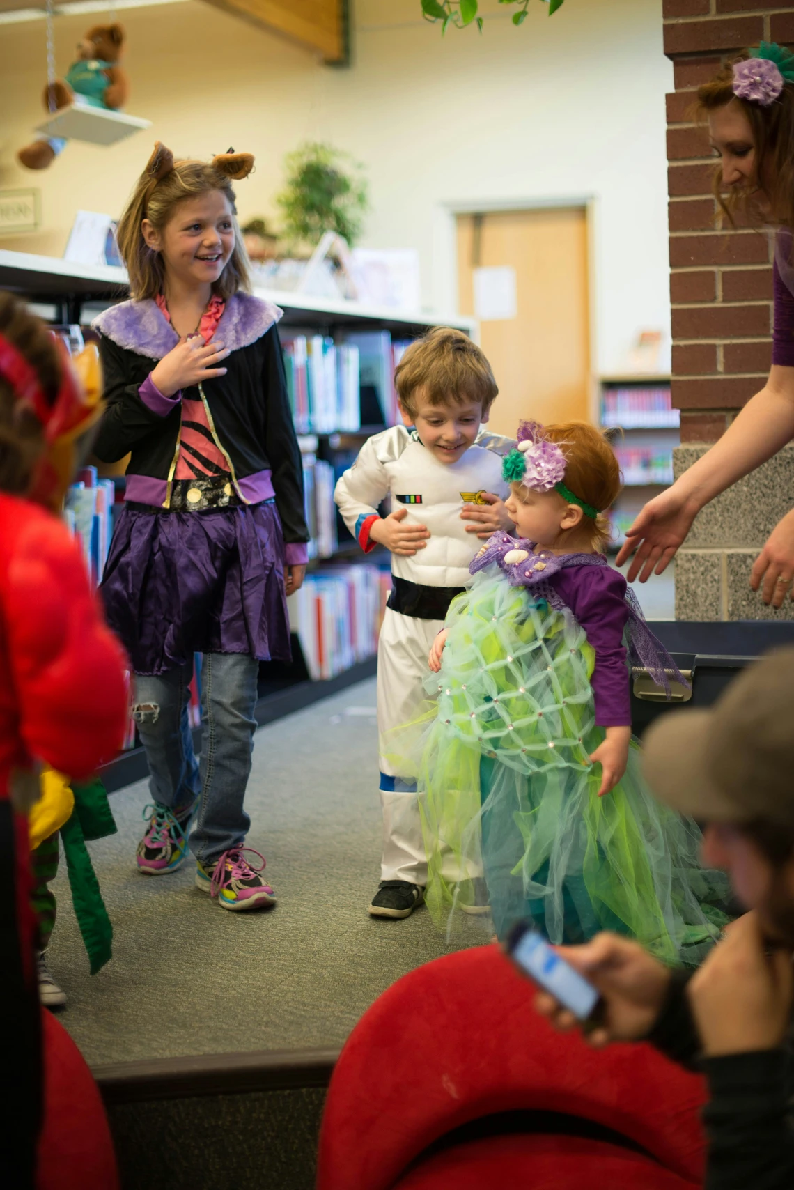 Kids celebrating a costume party in a school library