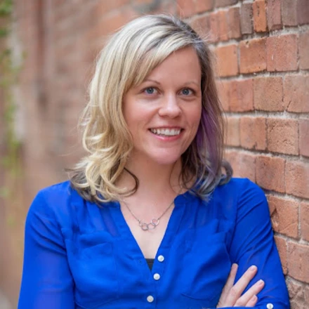 Headshot of a woman in a blue shirt.