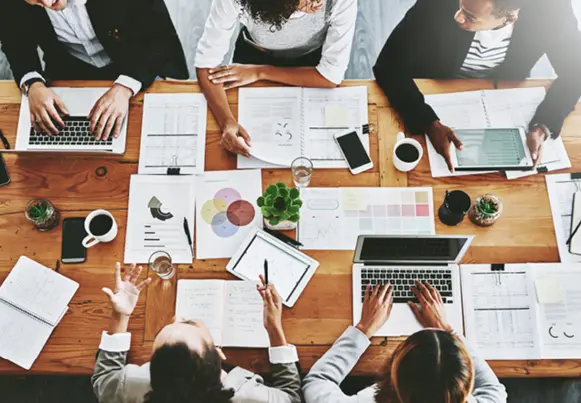 An image of people working together at a table
