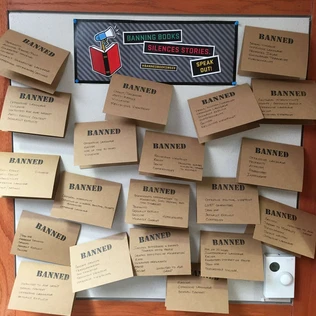 A Banned Books Week display from Little Rock with a whiteboard header: "Banning books silences stories. Speak out!"