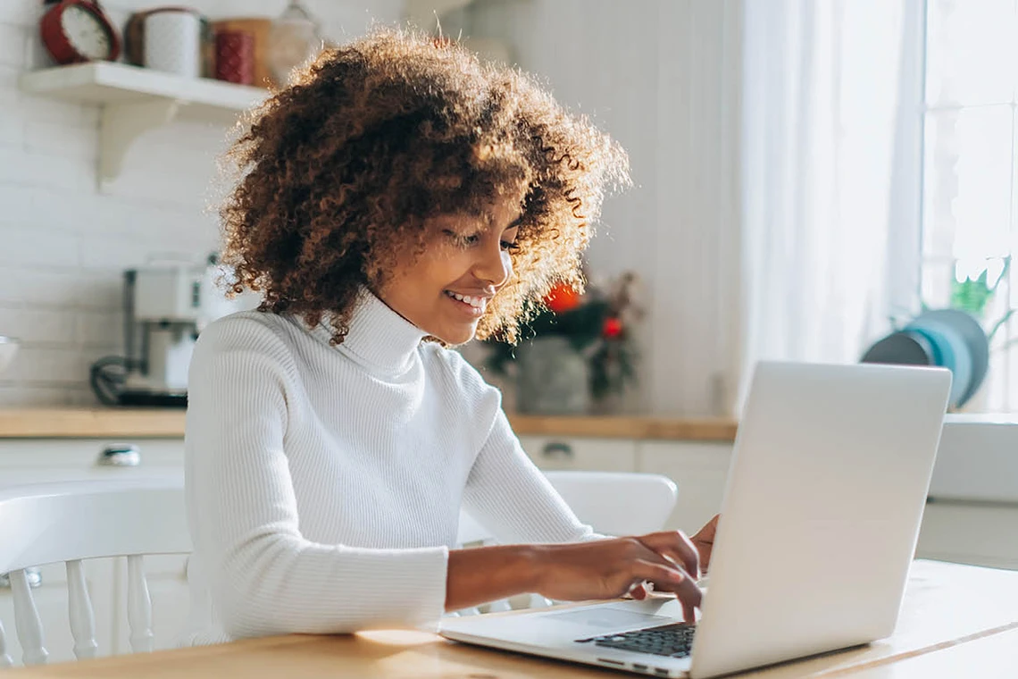 Young professional on laptop at home